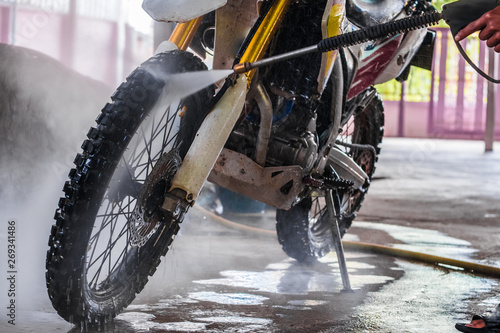A man cleaning motorcycle