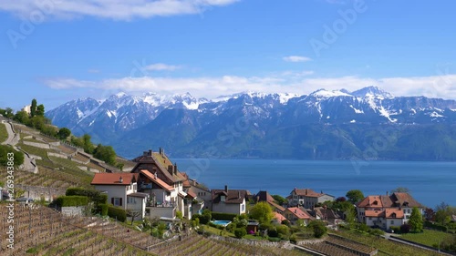 Scenic view in Lavaux vineyard, Le Chatelard hamelet in the foreground, Lake Leman and snow-capped French Alps across Lake Leman (Lake Geneva). Static shot