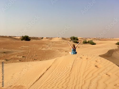 Fototapeta Naklejka Na Ścianę i Meble -  Girl on top of a dune in the desert