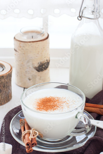 Homemade kefir in a glass cup with cinnamon and sugar, selective focus