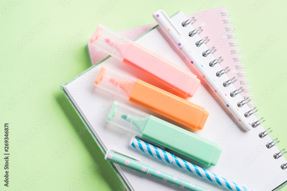 Pastel green back to school flat lay with copybooks and colorful stationery. Blogging concept Pastel green back to school flat lay with copybooks and colorful stationery. Blogging concept