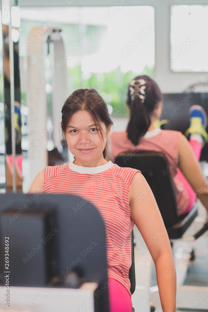 Asian woman work out exercise at Gym weight loss