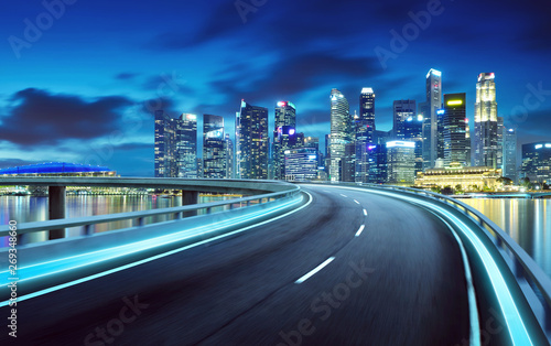 Highway overpass modern Singapore city skyline background . Night scene .
