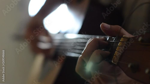 close up hand playing guitar 