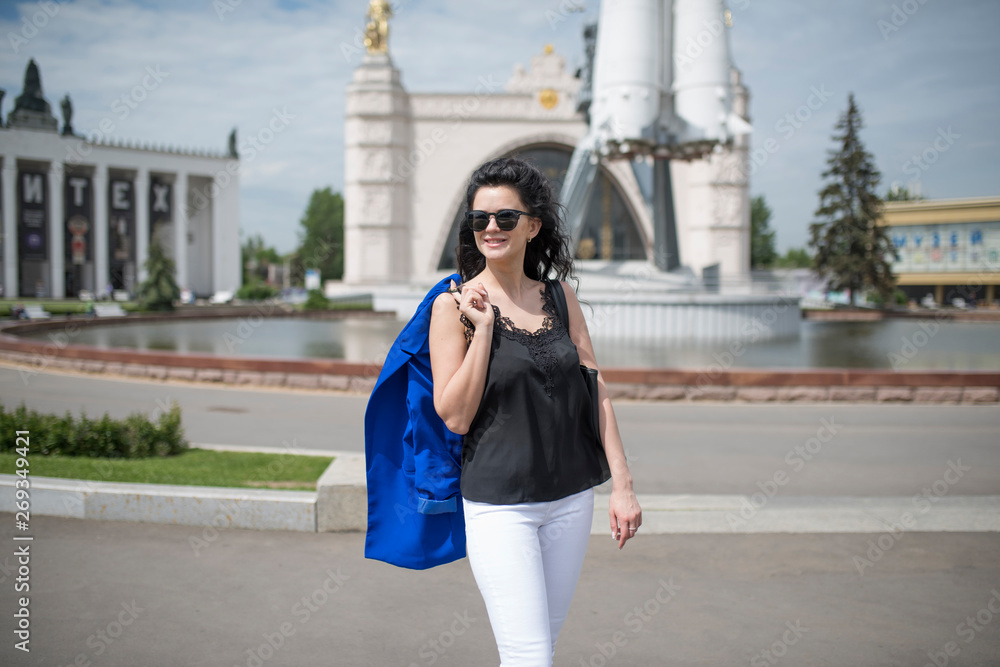 portrait of black-haired girl in white trousers and blue jacket portrait of black-haired girl in white trousers and blue jacket
