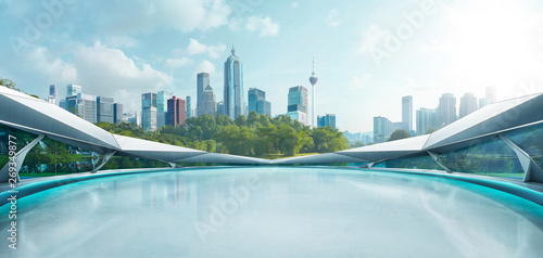 Panoramic view of futuristic geometric shapes design empty floor with morden city skyline . Morning scene .
