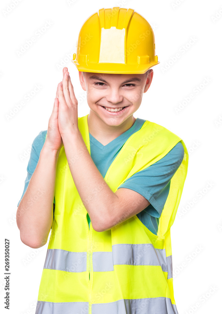 Funny Handsome Teen Boy wearing Safety Jacket and yellow Hard Hat. Portrait of Happy Child Makes Hands Gesture and Looking at Camera, isolated on white background. Funny Handsome Teen Boy wearing Safety Jacket and yellow Hard Hat. Portrait of Happy Child Makes Hands Gesture and Looking at Camera, isolated on white background.