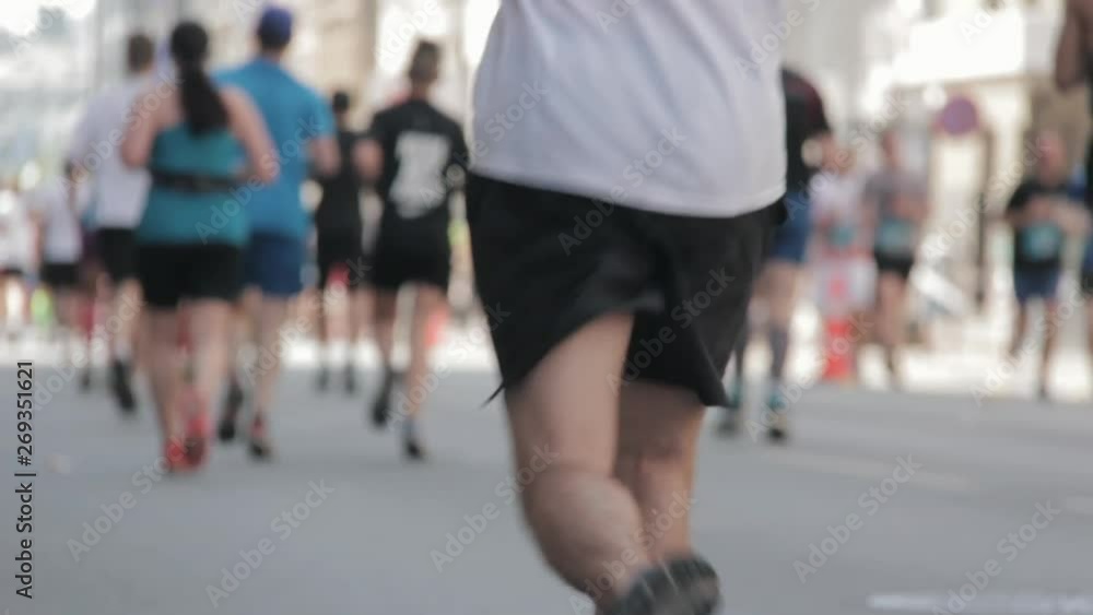 Marathon Runners Crowd Bottom-view Legs. Athletes Runing Out Off Focuss. Blurred Runner Feet Running Marathon. Tet Riga Marathon Latvia Marathon Runners Crowd Bottom-view Legs. Athletes Runing Out Off Focuss. Blurred Runner Feet Running Marathon. Tet Riga Marathon Latvia