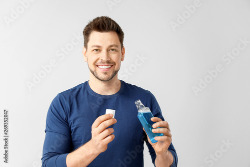 Man with mouth rinse on lig...