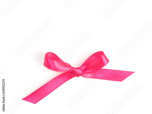 Pink satin ribbon bow on white background