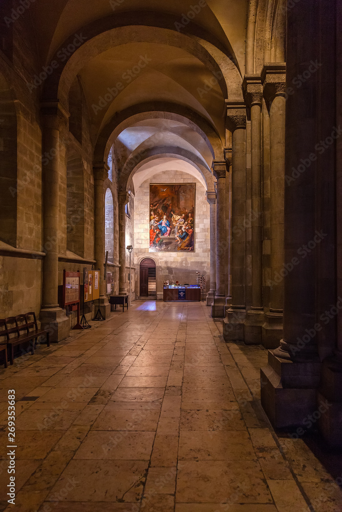 Interior of the Lisbon Cathedral or Se de Lisboa aka Santa Maria Maior Church, Portugal. Romanesque aisle parallel to the nave with round arches