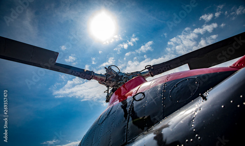 red and black helicopter standing at the airfield motor close up