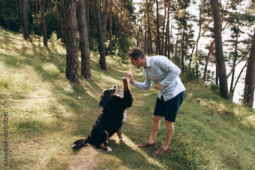  Man playing with a dog in the woods