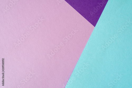 Multicolored paper background in soft blue, violet and lilac colors.