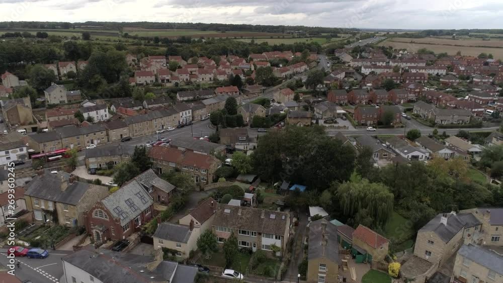 Drone over Bramham village with bus driving through village and motorway Drone over Bramham village with bus driving through village and motorway