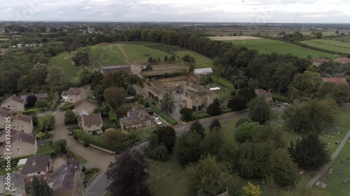 Drone revealing a church in a village in Bramham, Yorkshire photo