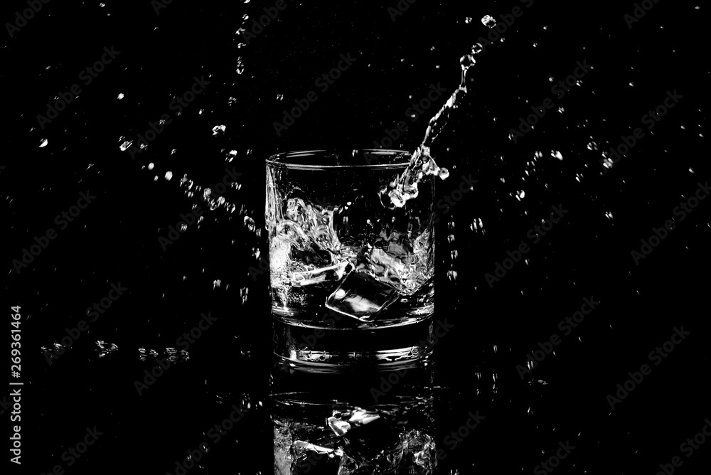 Isolated shot of whiskey with splash on black background Isolated shot of whiskey with splash on black background