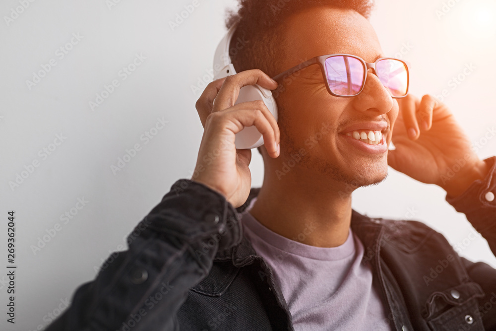 Fototapeta premium Smiling black guy listening to good music