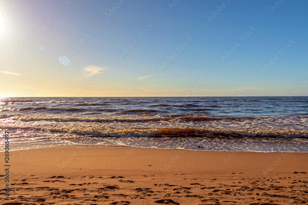 Calm Baltic sea seashore beach background in golden hour