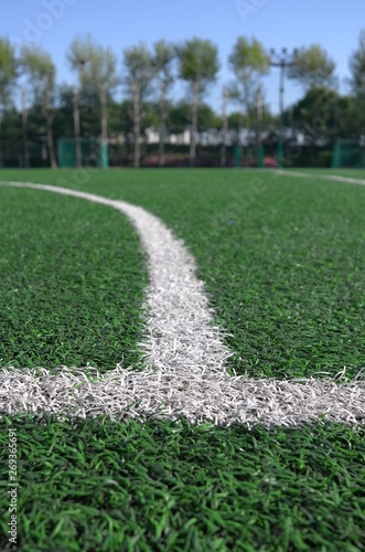 Boundery lines on artificial lawn of soccer field photo