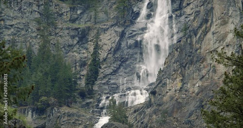 Bottom of Waterfall Mist with Large Rocky Cliff Face photo