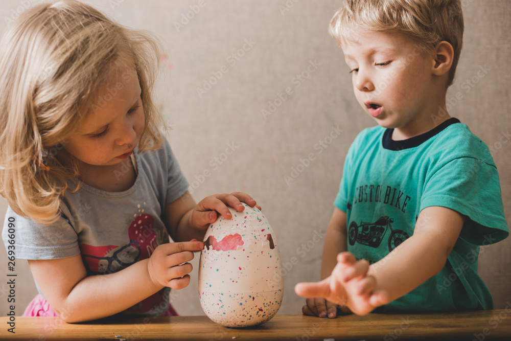 Fototapeta premium children play with hatched toy chicken