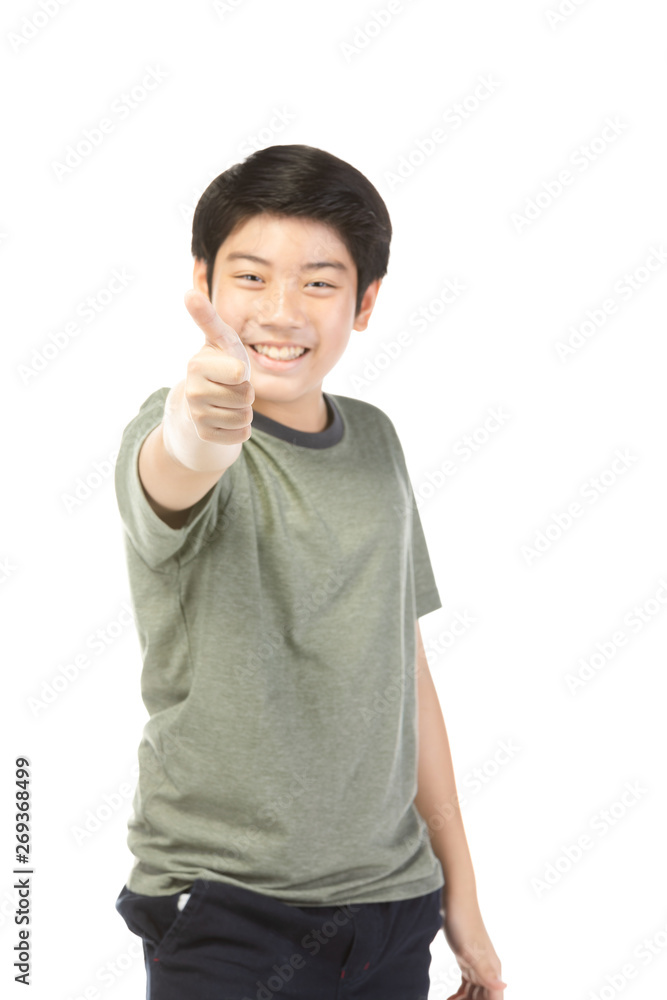 Asian excited boy in green-shirt giving thumbs-up. Asian excited boy in green-shirt giving thumbs-up.