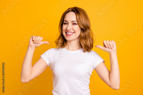 Close up photo amazing beautiful she her lady thumbs indicate direct chest self-confident toothy I am best choice choose pick select me advice wear casual white t-shirt isolated yellow background