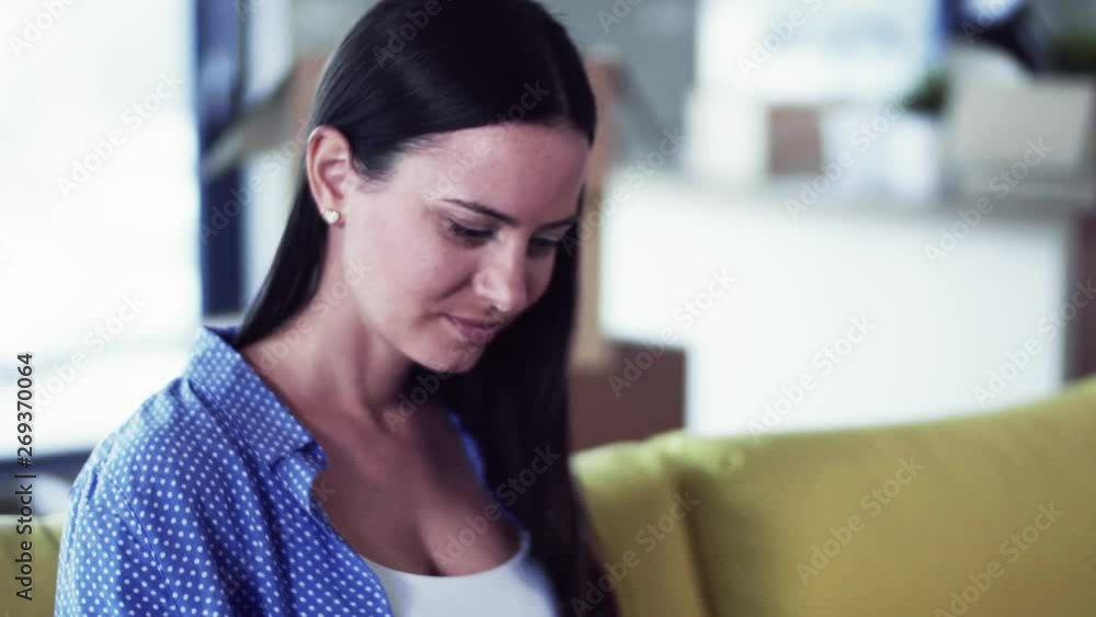 A young woman moving in new home, using laptop. A young woman moving in new home, using laptop.