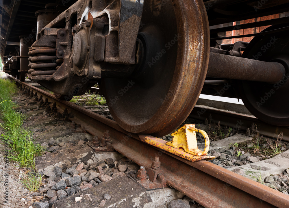 A closeup view of the wheels of a train wagon