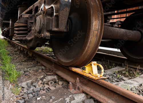 A closeup view of the wheels of a train wagon