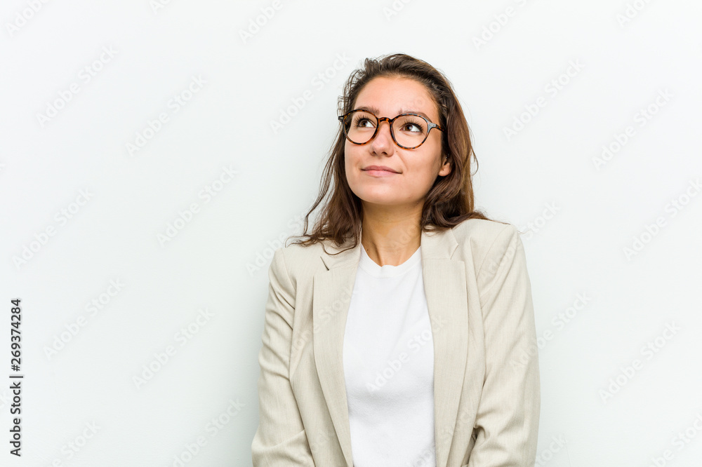 Young european business woman dreaming of achieving goals and purposes
