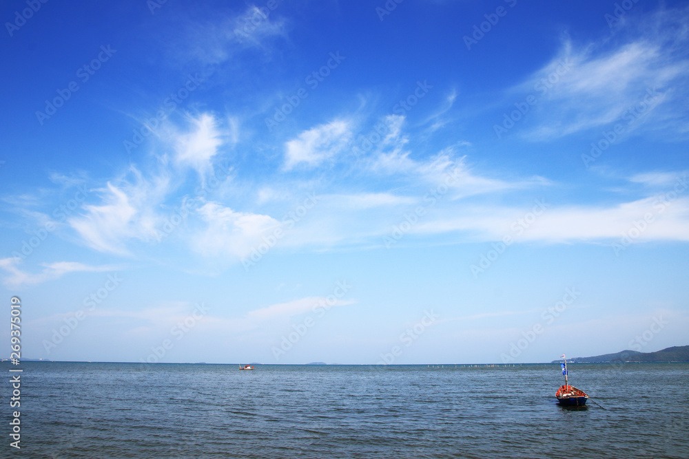 Fishing boats in the bay and bright sky