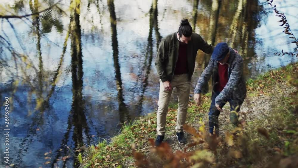 Senior father and his son walking in nature, talking. Senior father and his son walking in nature, talking.