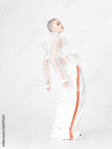 Model in futuristic outfit bending back