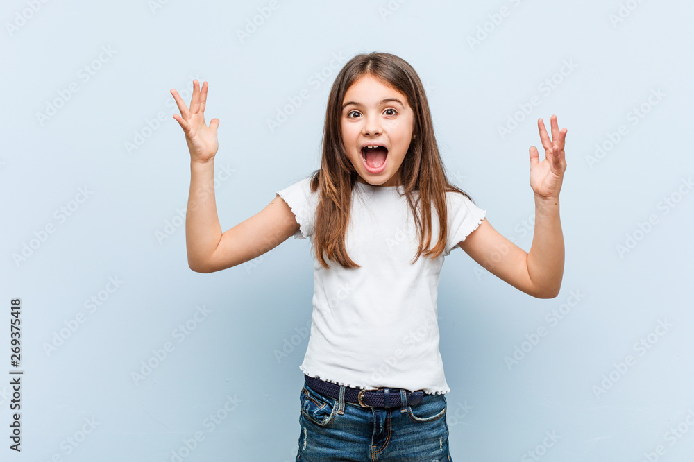 Cute girl receiving a pleasant surprise, excited and raising hands. Cute girl receiving a pleasant surprise, excited and raising hands.