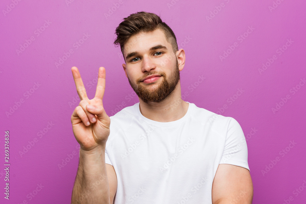 Young handsome caucasian man showing number two with fingers. Young handsome caucasian man showing number two with fingers.