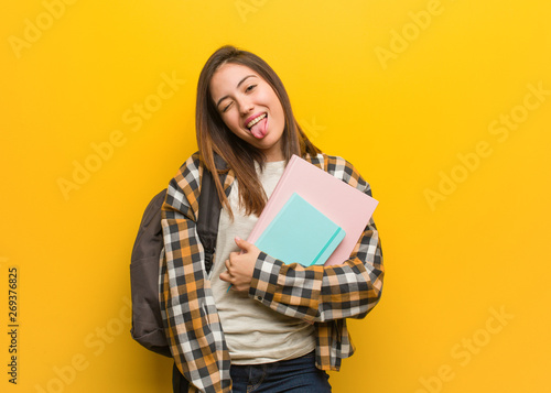 Young student woman funnny and friendly showing tongue