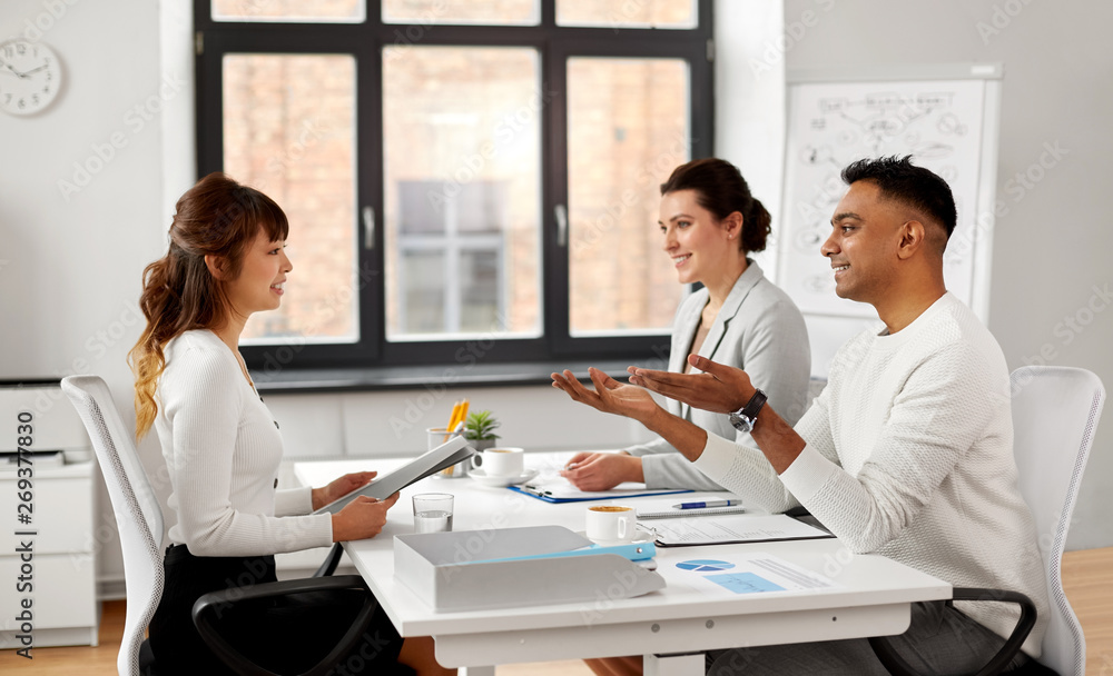 new job, hiring and employment concept - international team of recruiters having interview with asian female employee at office