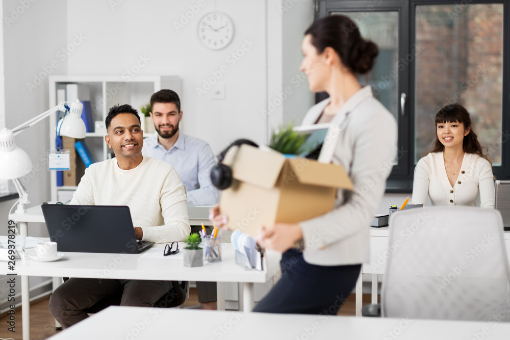 business, job and quit concept - female office worker with box of personal stuff and happy smiling colleagues business, job and quit concept - female office worker with box of personal stuff and happy smiling colleagues