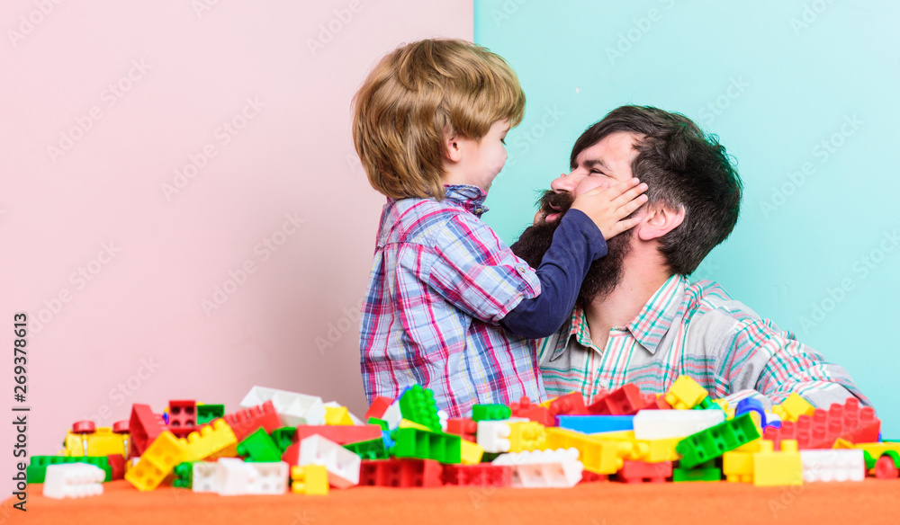 happy family leisure. small boy with dad playing together. father and son play game. building home with colorful constructor. child development. We can do it. Childhood and happiness happy family leisure. small boy with dad playing together. father and son play game. building home with colorful constructor. child development. We can do it. Childhood and happiness