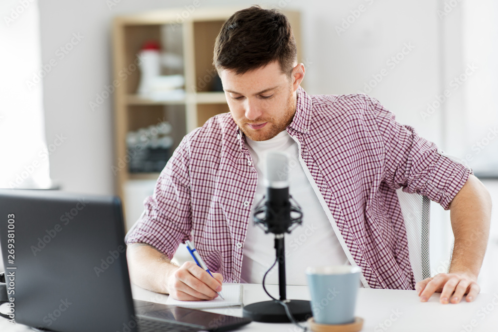 technology, mass media and podcast concept - male audio blogger with laptop computer, microphone and notebook broadcasting at home office technology, mass media and podcast concept - male audio blogger with laptop computer, microphone and notebook broadcasting at home office