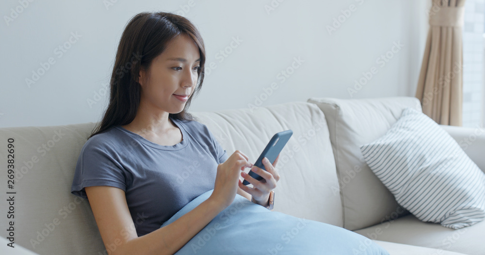 Woman use of smart phone at home Woman use of smart phone at home