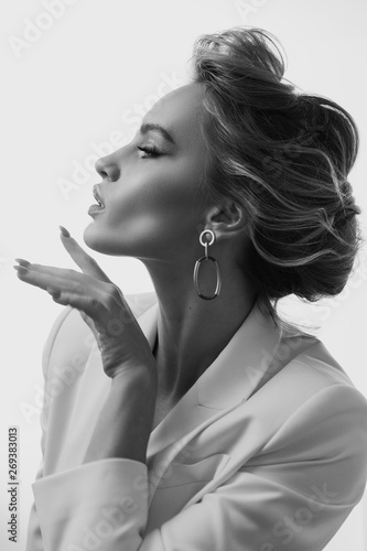 Beautiful and fashion girl with a make-up in a white jacket and a stylish haircut