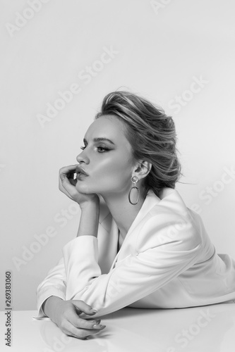 Beautiful and fashion girl with a make-up in a white jacket and a stylish haircut