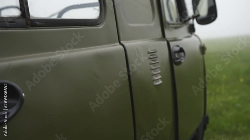 old soviet military car in the fog on the meadow