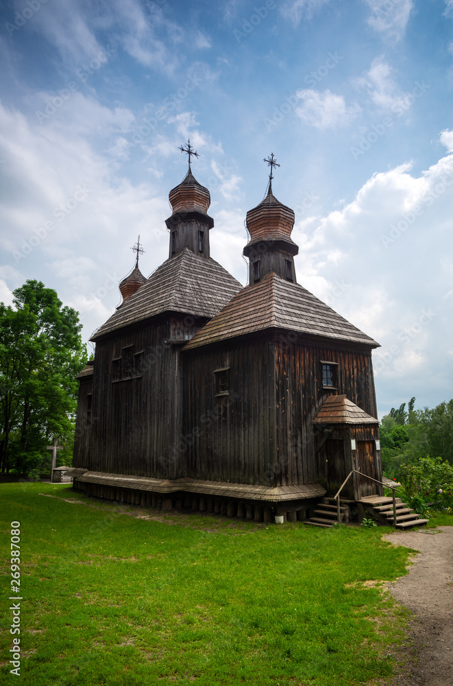 Orthodox wooden church in the Ukrainian village under dramatic skies