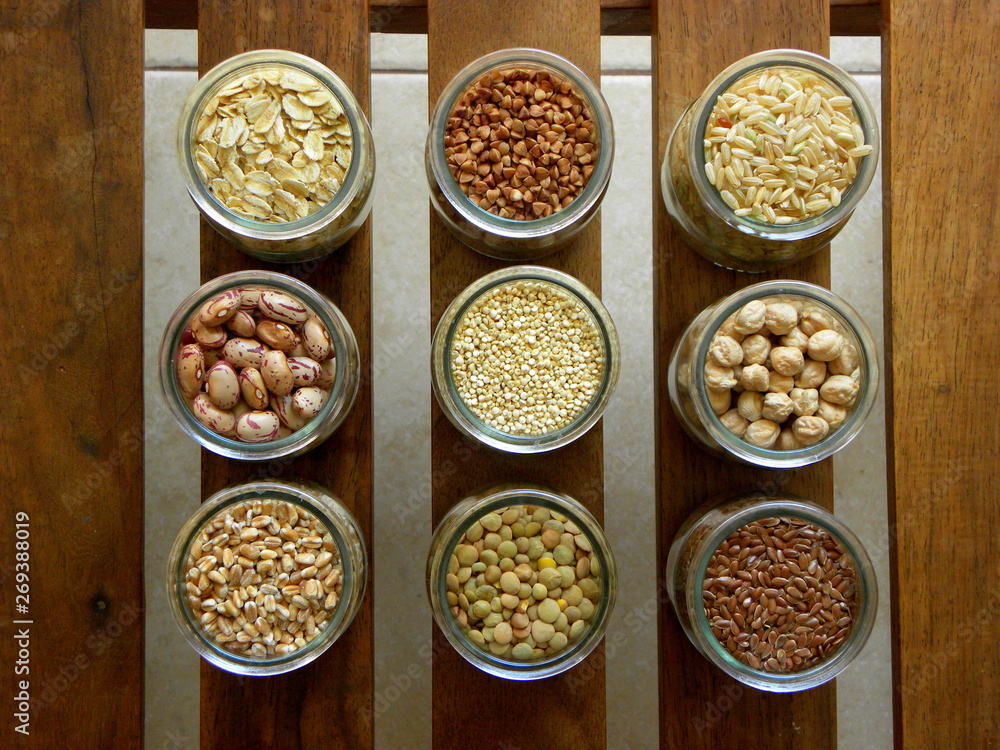 A collection of cereals and legumes on a wooden table A collection of cereals and legumes on a wooden table