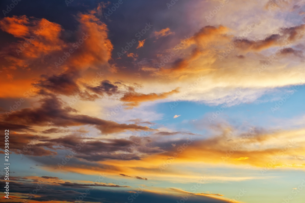 Fototapeta premium Beautiful dark fluffy cloudy sky. Sunset light.
