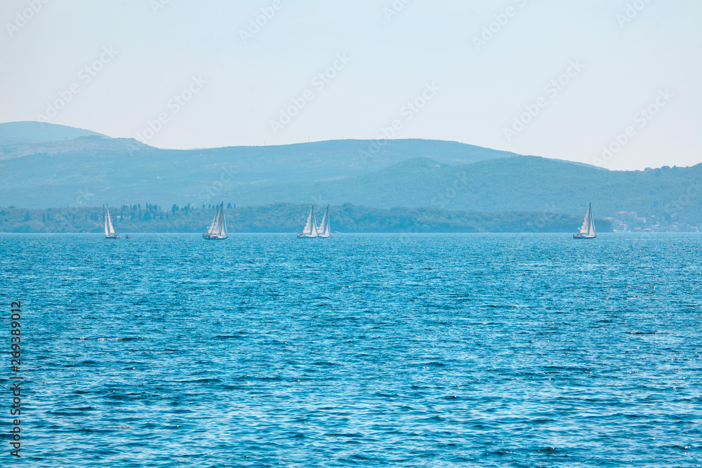 Obraz premium yachts with white sails in blue sea
